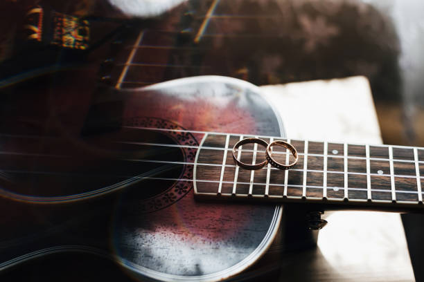 istock two gold wedding rings lie on guitar strings 1225216728