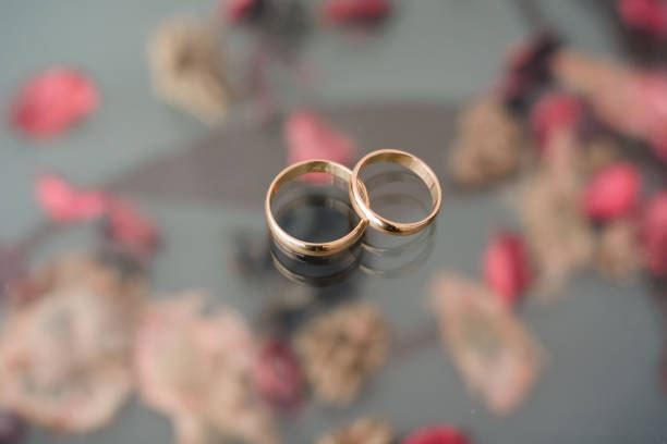 istock two traditional wedding gold engagement rings lie 1225216729