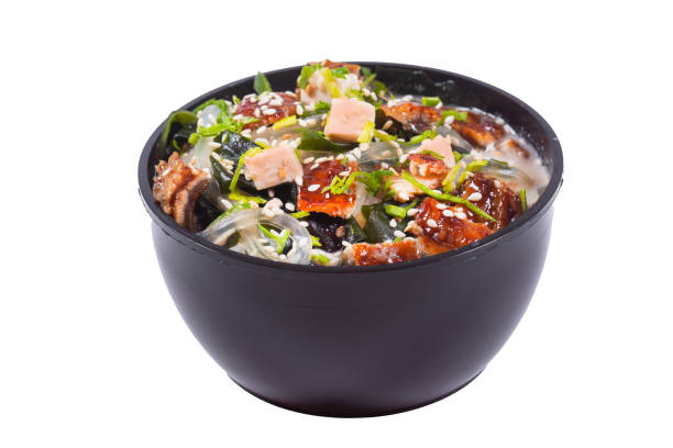 istock in a black plate or bowl, tom yam kimchi soup with chicken or eel fish, on an isolated white background 1225219461