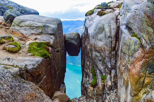 Nobody landscape of the famous Kjeragbolten. The most dangerous stone in the world. Kjeragbolten is a rock stuck at an altitude of 984 meters above Lysefjorden on mountain Kjerag, Norway.
