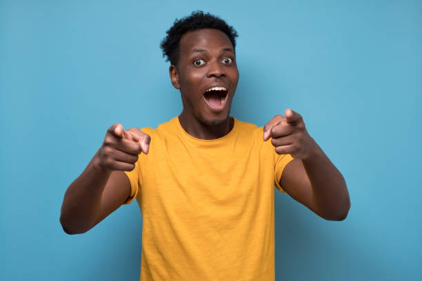istock Cheerful attractive african man pointing on you making a choice. 1225223095
