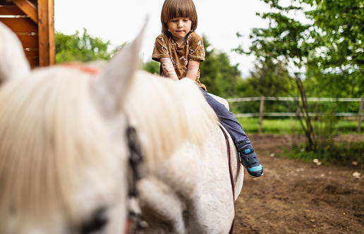 Little boy riding a horse