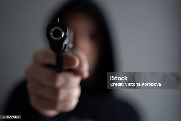 Criminal Aiming Gun Camera Threatening Burglar At Victim Stock Photo - Download Image Now