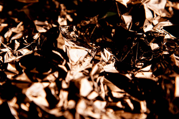 istock Thin sheet of silver leaf background with shiny crumpled uneven surface 1225227107