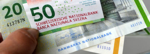 moneda suiza y danesa, corona danesa y franco suizo - swiss francs swiss currency switzerland finance fotografías e imágenes de stock