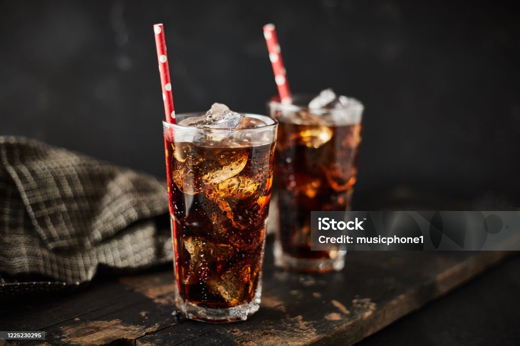 Close up glass of refreshing cola. Close up glass of refreshing cola with ice on table. Cola Stock Photo