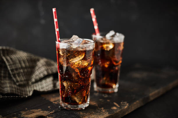 Close up glass of refreshing cola. Close up glass of refreshing cola with ice on table. carbonated stock pictures, royalty-free photos & images