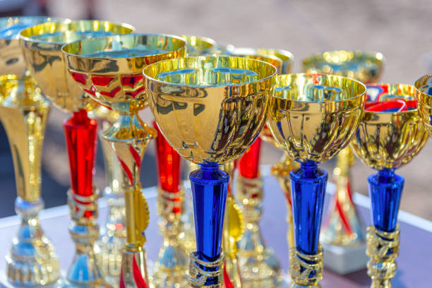 istock many gold cups of different sizes on a blurred background 1225230542
