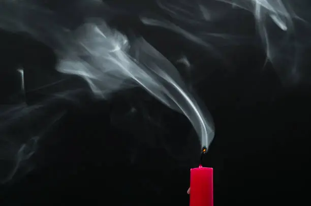 Photo of Red candle with smoke
