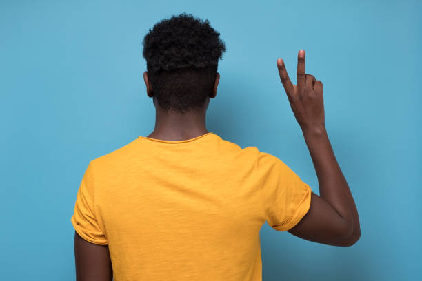 istock African american man showing two finger scissors gesture turning back 1225231489