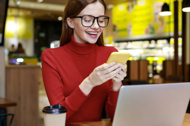 jeune femme textant dans le café - red text messaging cafe teenage girls photos et images de collection