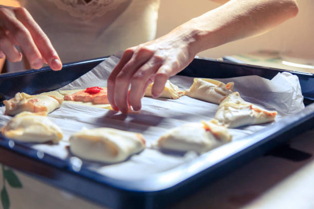 istock Young woman cooking at home 1225233004