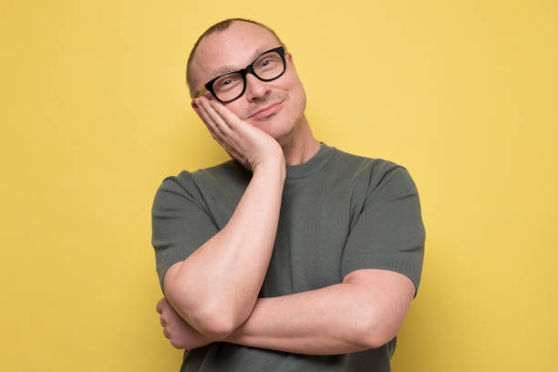 istock Young handsome man with glasses thinking or dreaming about future. 1225233101