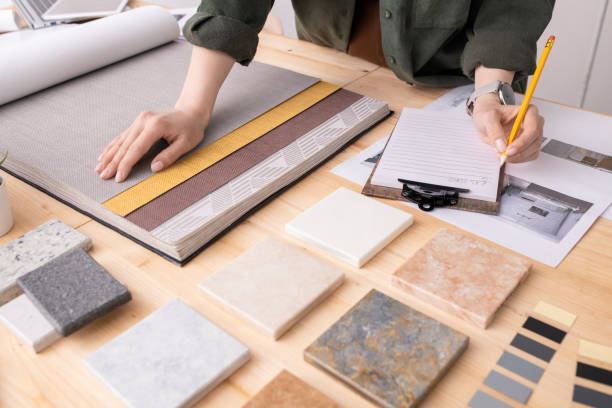 istock Hands of female interior designer with pencil over paper making notes 1225234137