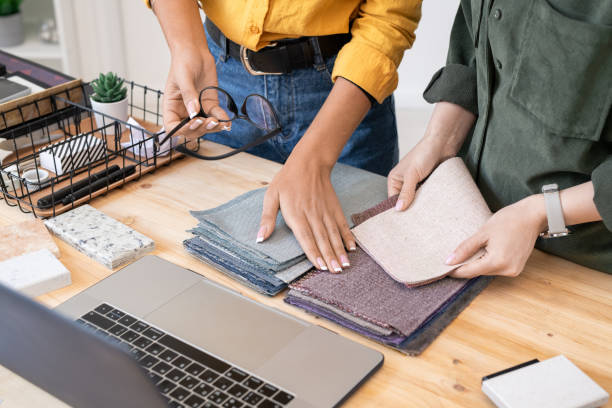 istock Hands of young designer on top of textile samples during discussion 1225234160