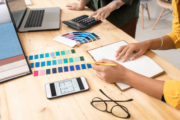 istock Young designer with pencil pointing at color swatches while making notes 1225234163