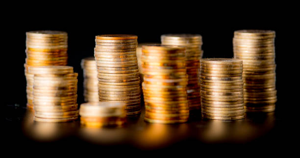 istock Stack of golden coins isolated on black background 1225236679