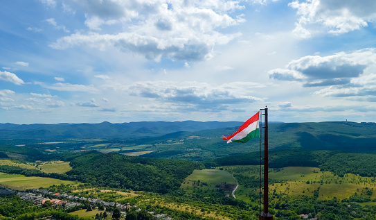 Beautiful landscape view foreground with the hungarian flag, Füzér Castle, Hungary