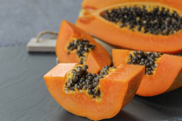 istock papaya pieces on a grey background 1225237029