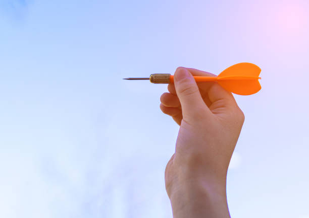 istock A child's hand holds a dart. Throwing at the target. Game competition 1225237123