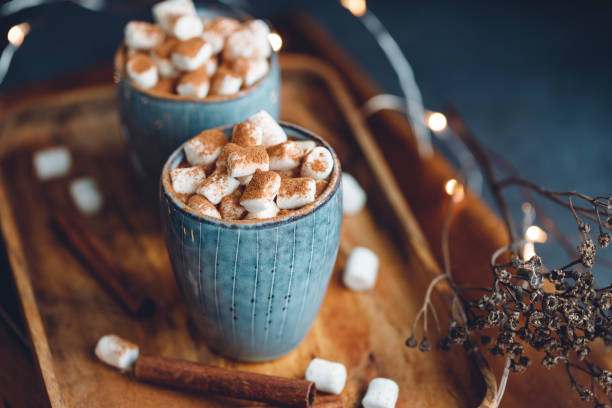 istock Hot chocolate with marshmallow and cinnamon in a blue ceramic cups on a table. The concept of cosy holidays and New Year. 1225238985