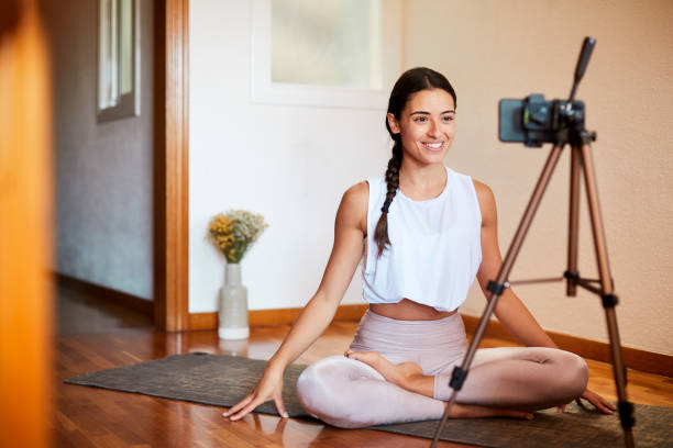 istock One young woman fallowing an onlline yoga class. 1225239592