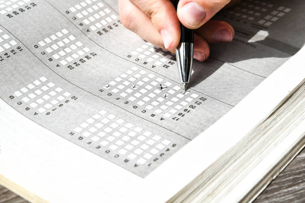 istock Student hand with pencil for the exam. printed school test, home education 1225241208