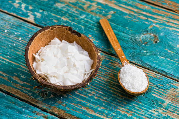 istock Coconut flakes and grated coconut on wooden spoon. 1225242503