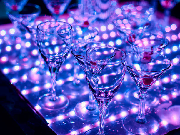 istock empty glasses of alcoholic drinks on table with a bright light ultraviolet 1225242693