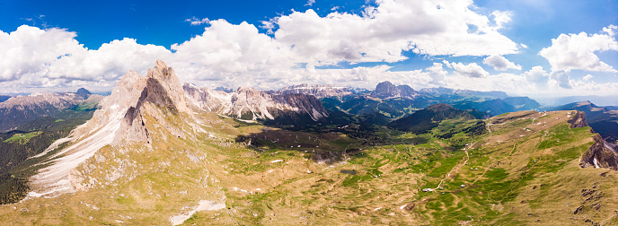 Amazing aerial top view on Seceda Mount peak and valley from drone. Trentino Alto Adige, Dolomites Alps, South Tyrol, Italy, Europe near Ortisei. Odle mountain range and Puez massif, Val Gardena
