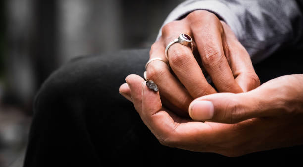 istock A Hand Holding Cream Hashish Hash on the Tip of the Forefinger, Ruby Ring 1225254403