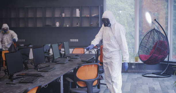 istock Men in hazmat suits disinfecting office 1225255283