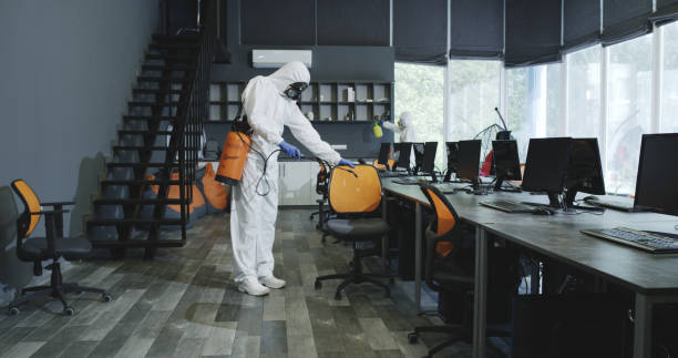 Men in hazmat suits disinfecting office Full shot of men in hazmat suits disinfecting office office cubicle mask stock pictures, royalty-free photos & images