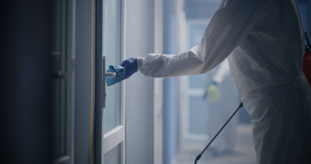 istock Men in hazmat suits disinfecting building 1225255340