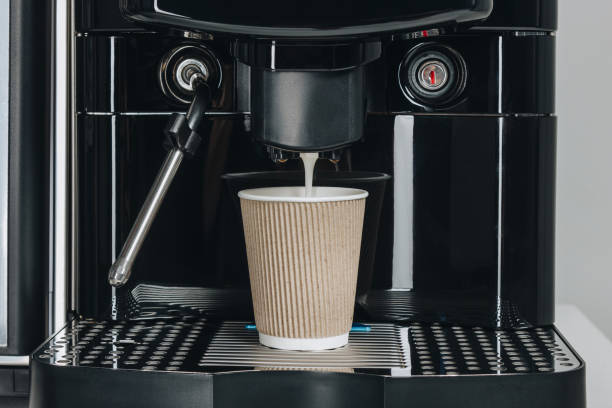istock Fresh coffee from coffee machine brewing to paper cup 1225259739