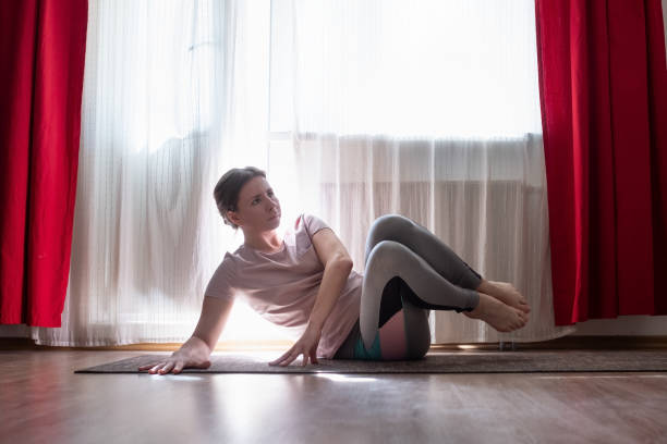 istock Caucasian young woman doing pilates or abs exercise for core muscles at home 1225260826