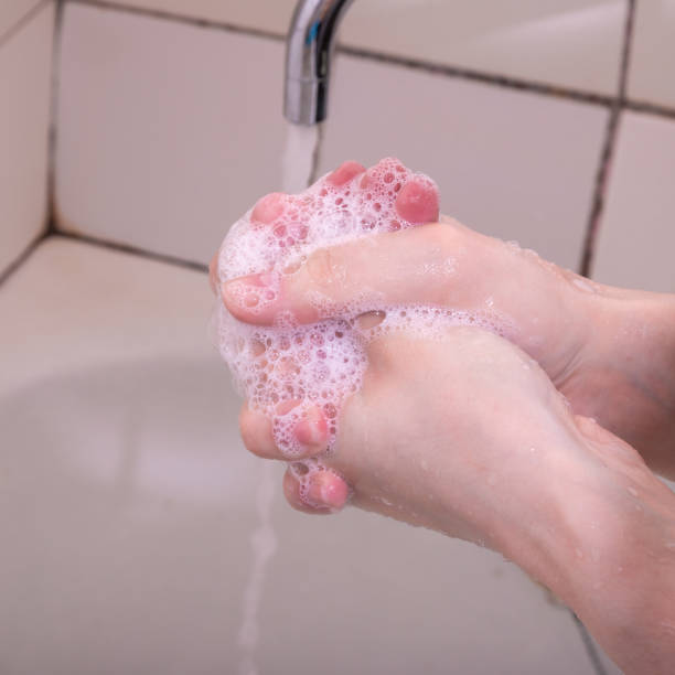 istock Woman washes hands with liquid soap, soap suds, close-up 1225261017