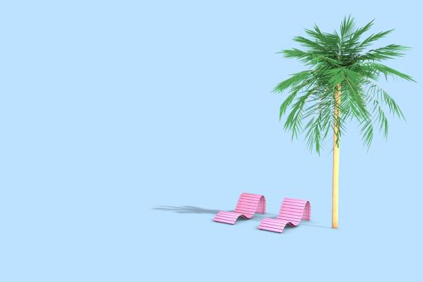 Paradise island in the ocean. Beach chair and an umbrella under a palm tree in the sand.