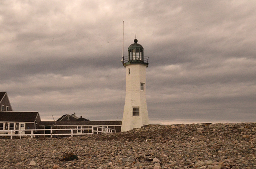 Gorgeous image of Old Scituate Light and rocky beach in Scitaute.