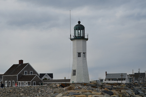 Over cast skies and clouds hanging over Old Scituate Light in Massachusetts.