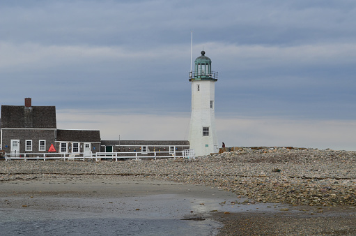 Old Scituate Light and rocky coast in Scituate harbor in Massachusetts.