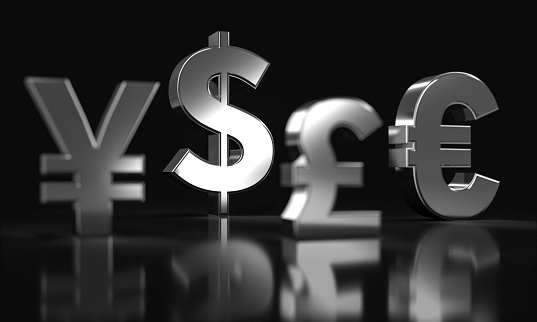 3D render of a silver Dollar, Euro, Japanese Yen and Pound sign on a black background