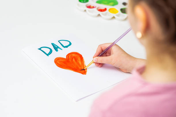 istock Child is drawing Father's day greeting card. 1225265692