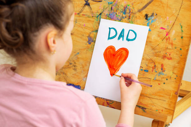 istock Child is drawing Father's day greeting card. 1225265754