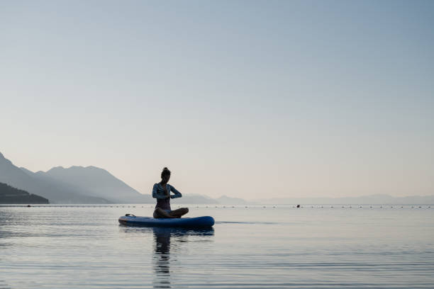 istock Young woman meditating in peace 1225265920