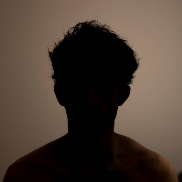 istock Silhouette man black and white curly hair touching scratching sad 1225268990