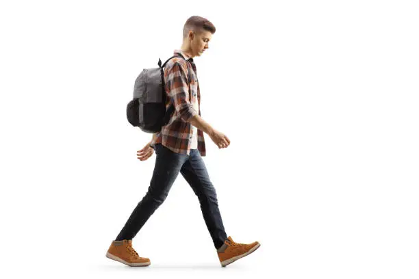 Photo of Sad male teenage student walking