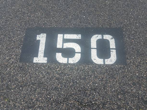 istock number 150 painted on black asphalt or pavement 1225271041