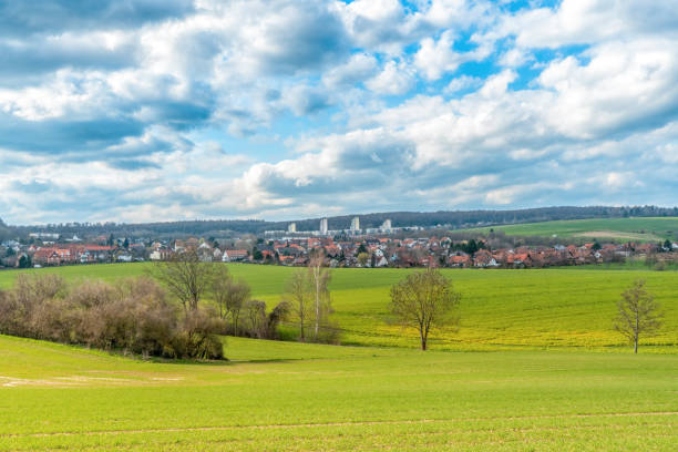 istock A landscape with meadows and fields in the background are three skyscrapers. The sky is drawn through 1225271967