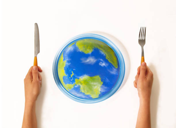 Earth globe on a plate with fork and knife, 3D rendering isolated on white background. The source of the map - http://visibleearth.nasa.gov/view.php?id=57730